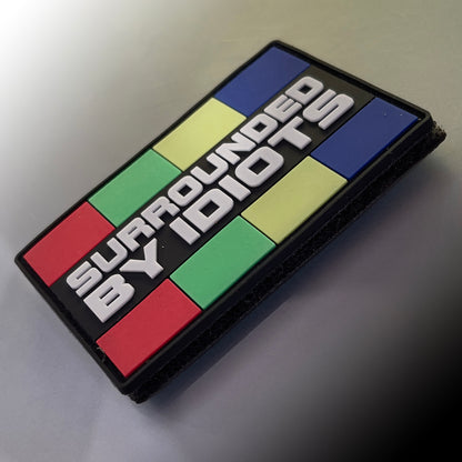 TACTICAL INNOVATIONS: Surrounded By Idiots PVC Morale Patch, 3"x2"